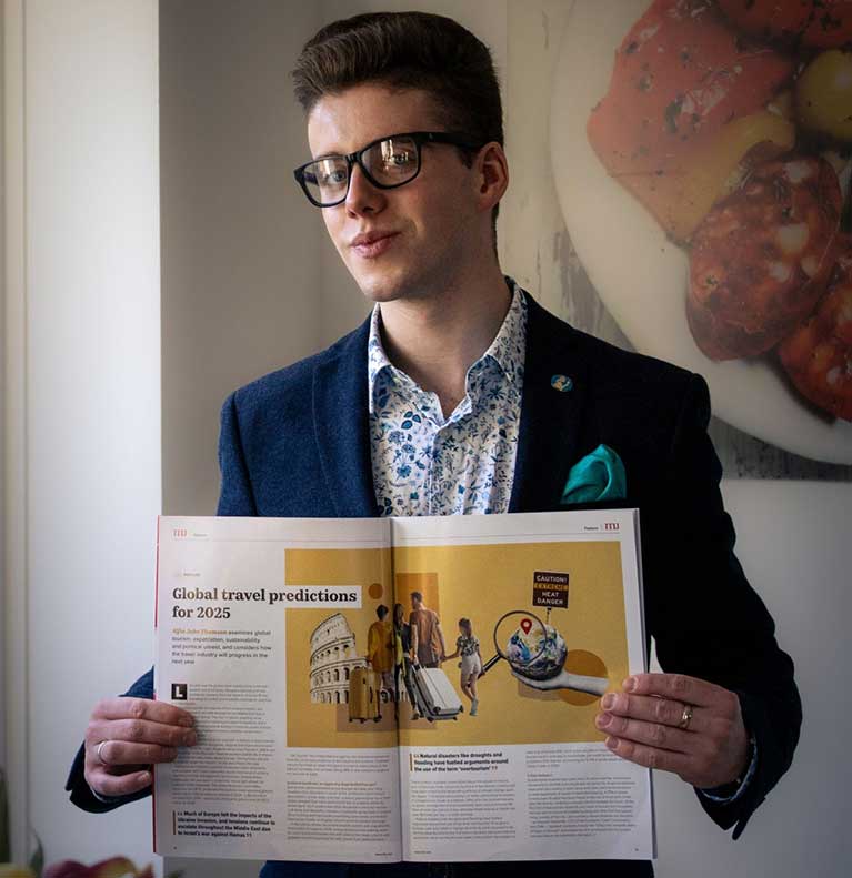 Alfie Thompson holding his article
