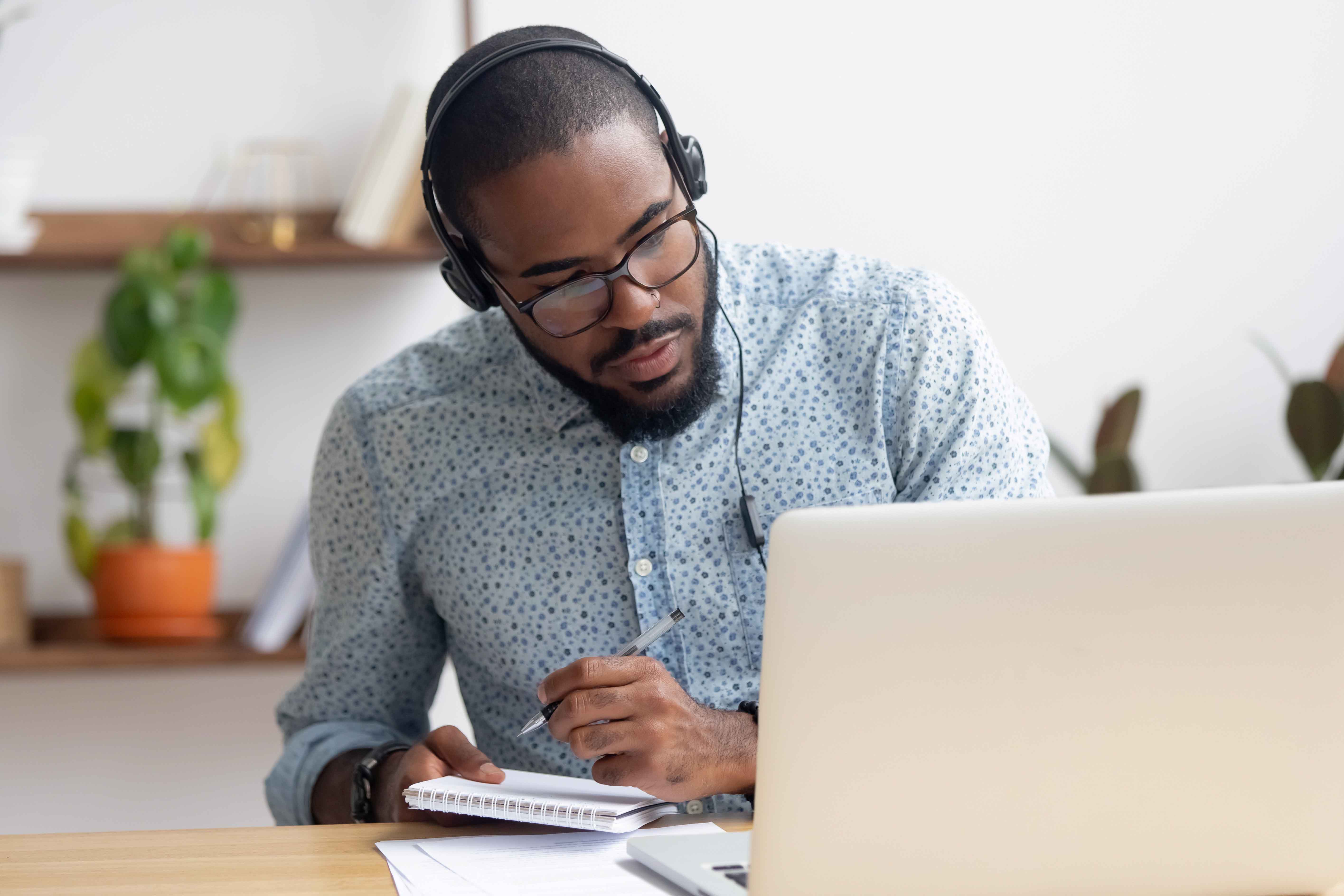 a man using a laptop with headphones on