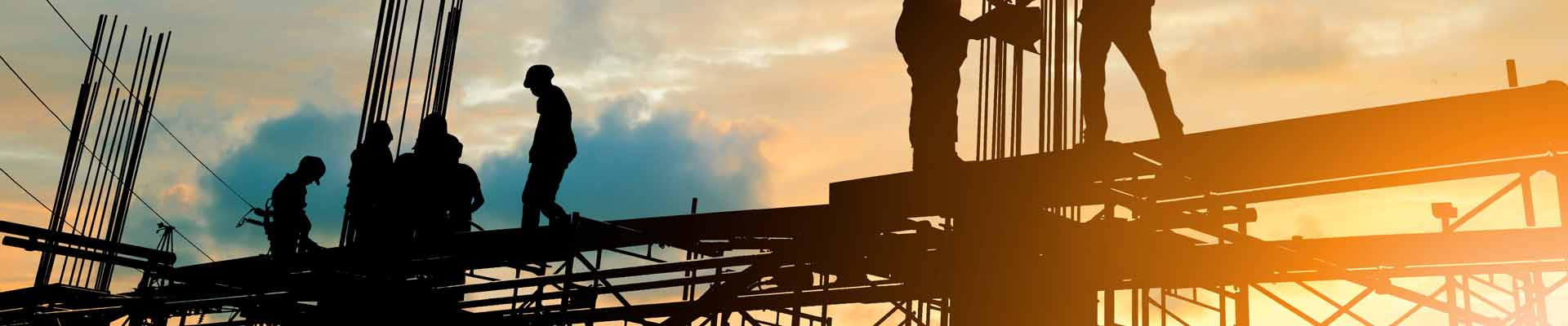 Silhouette of engineer and construction team working at site over blurred background sunset pastel for industry background with Light fair.
