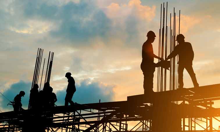 Silhouette of engineer and construction team working at site over blurred background sunset pastel for industry background with Light fair.