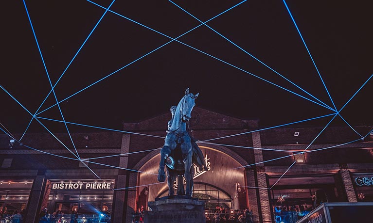 Godiva statue at night.