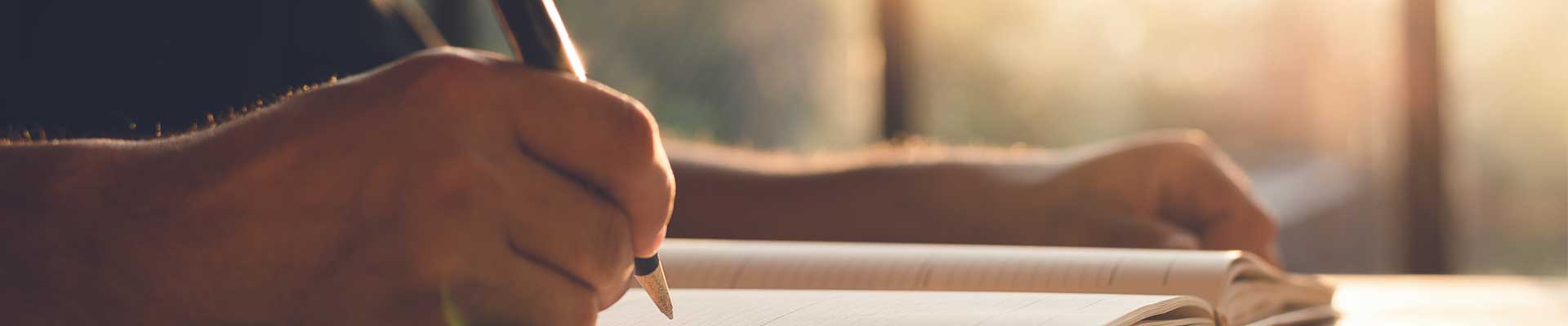 a creative writer making notes in the handbook