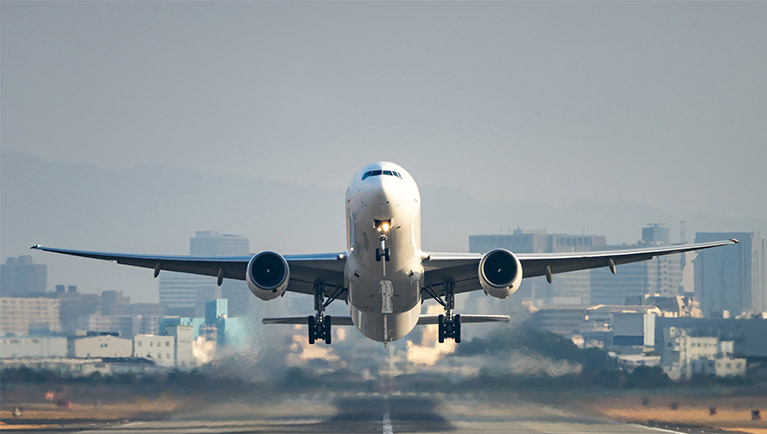 Airplane landing front-view Plane taking off from a runway