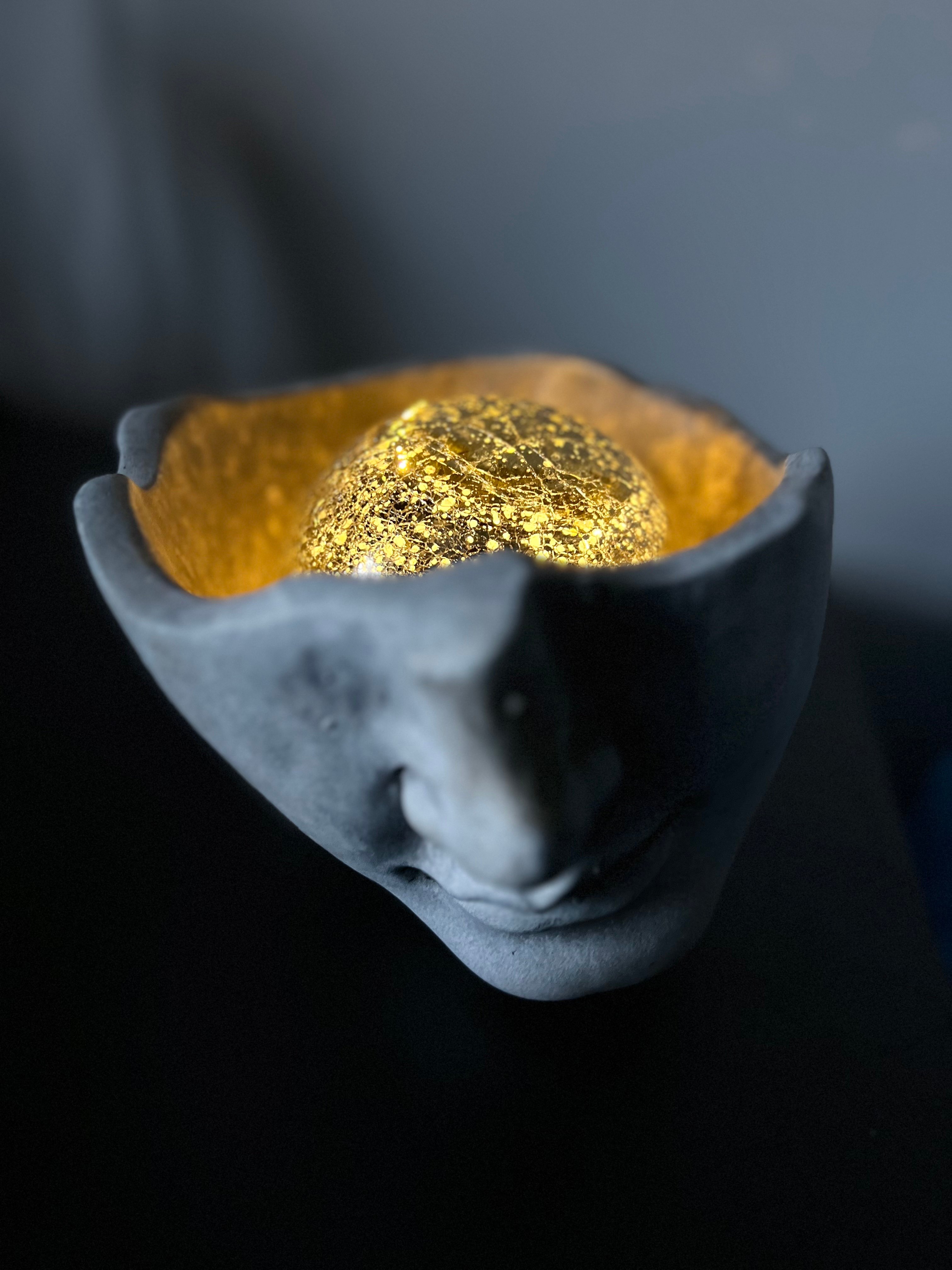 Clay head with gold 