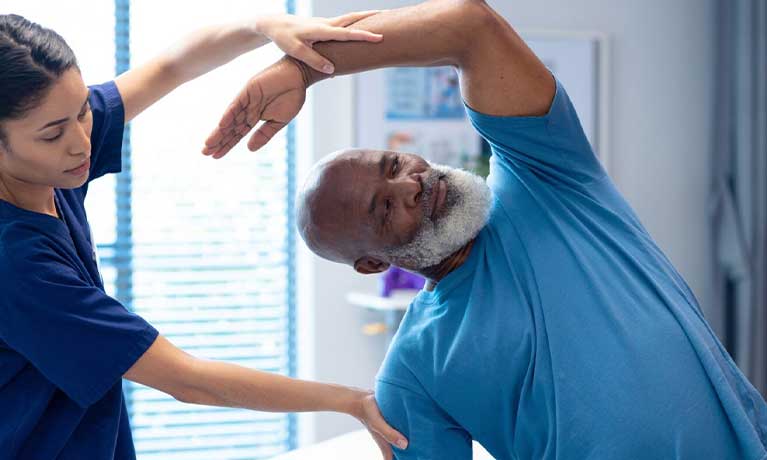 a female physiotherapist supervising a patient stretching