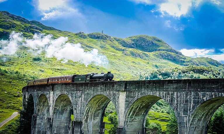 Steam Train travelling over a viaduct.