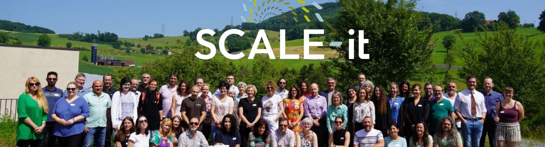 The project team group photo outside with the SCALE-it logo