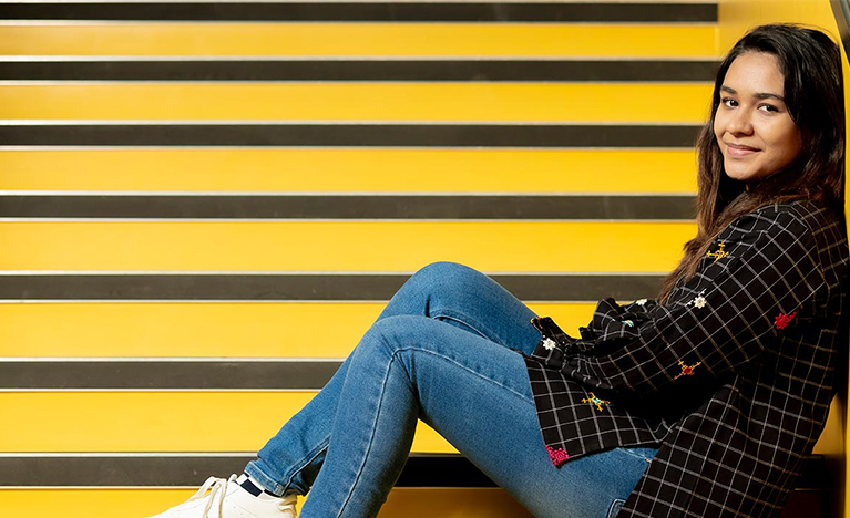 girl sitting on the stairs of the hub building