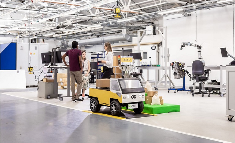 student working on machinery in a factory workshop