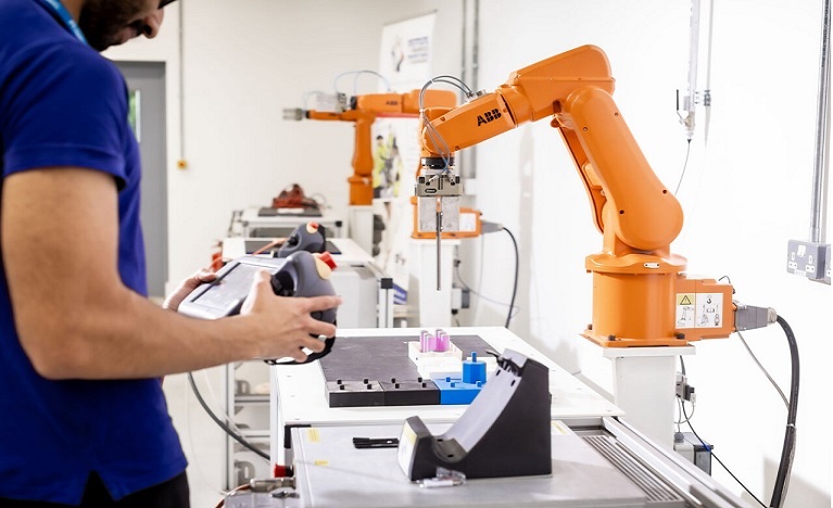 student operating machinery in a factory workshop