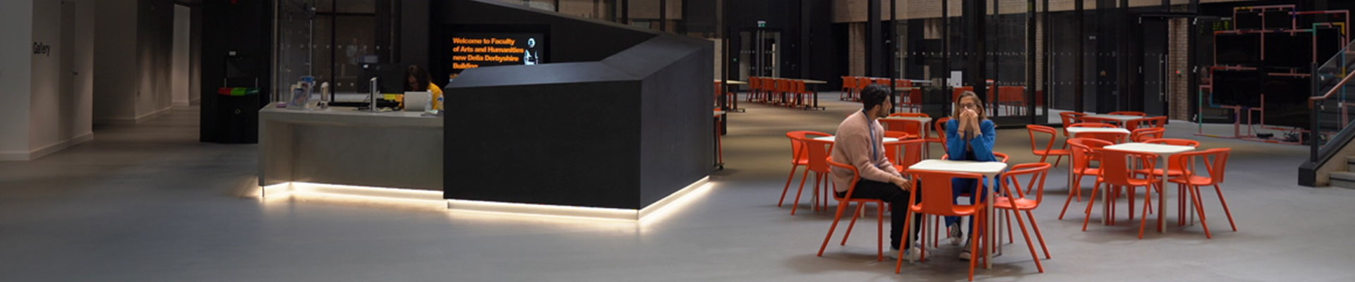 two people sitting together in a social space