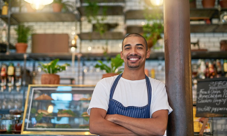 Portrait of a young entrepreneur standing in his business.