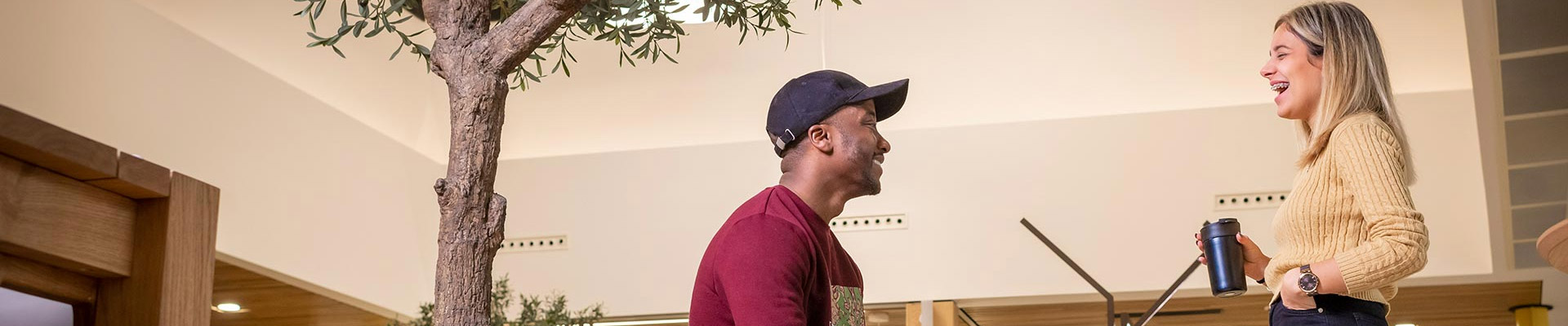 man and women talking to each other in a lobby