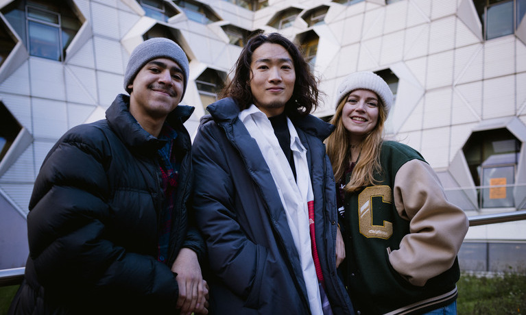 Three students laughing and talking