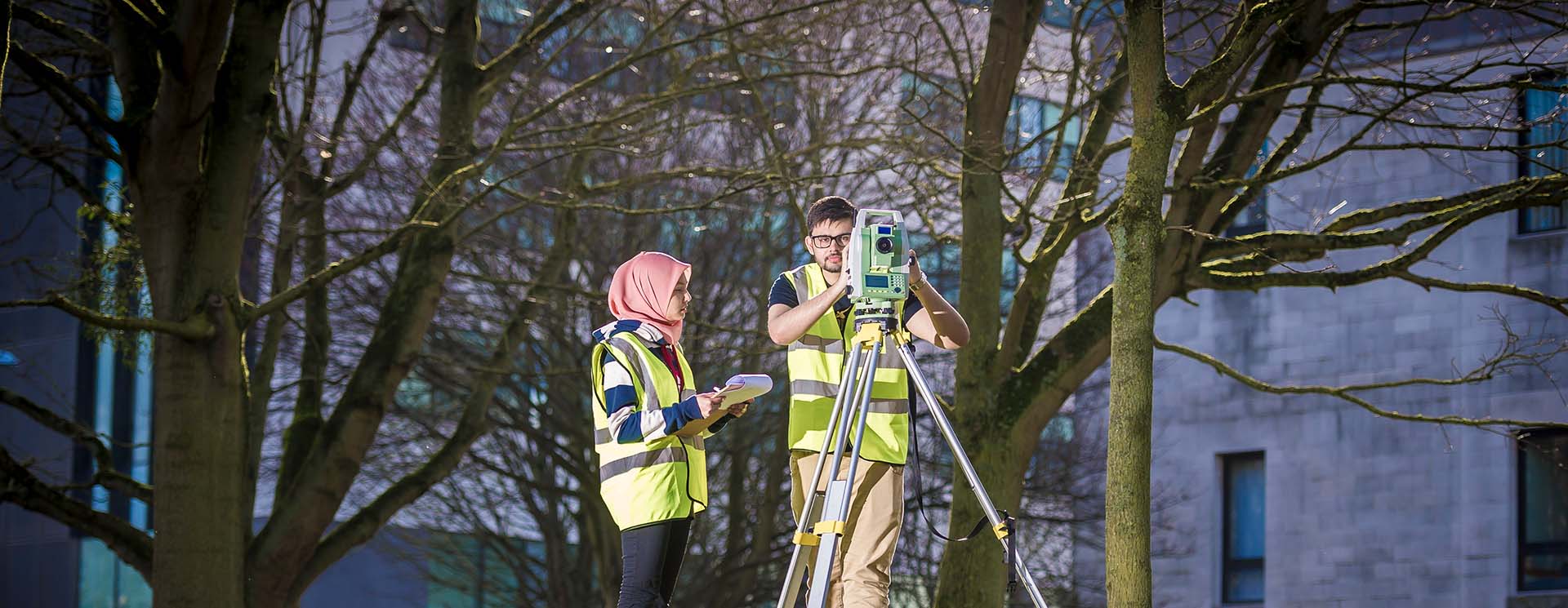 Students outside using construction equipment