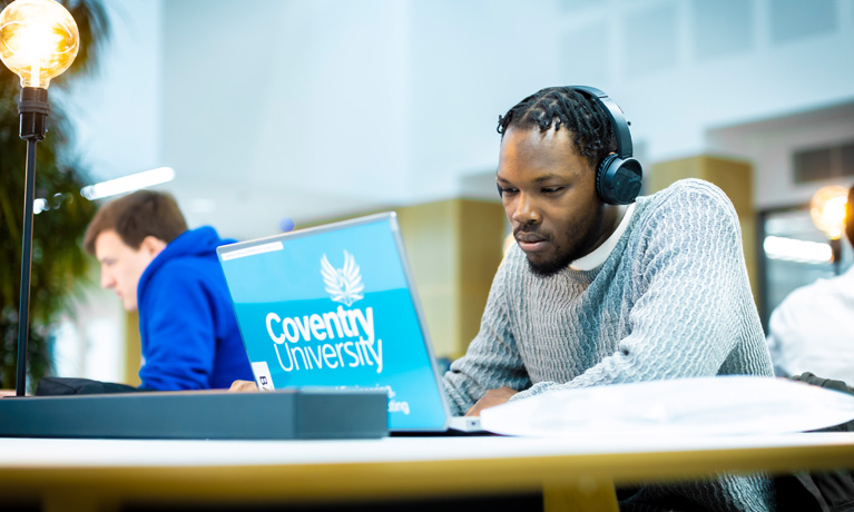 A student sat using a laptop in the digital literacy centre