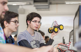 Group of students working on programming a car