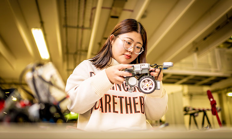 Student with model of car.