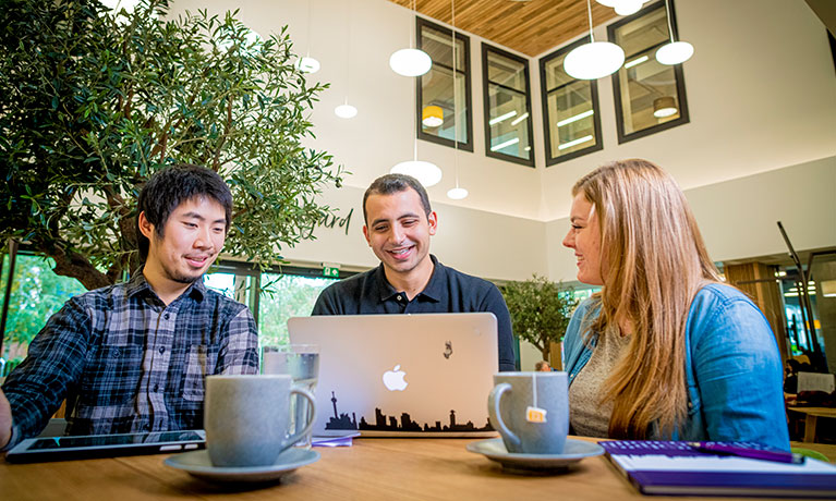 Students sat around a table in the Courtyard