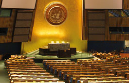 Empty indoor amphitheatre with benches on green carpet