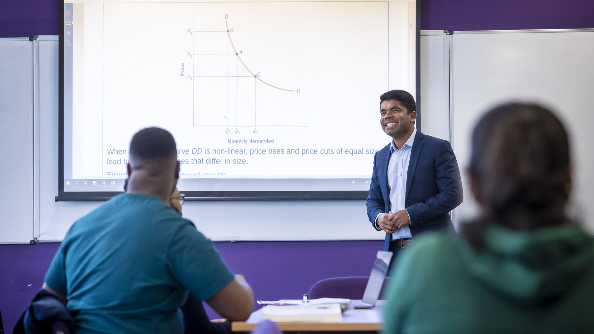 Lecturer presenting to students in a classroom