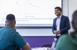 Lecturer presenting to students in a classroom