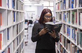 Student reading a book in the library