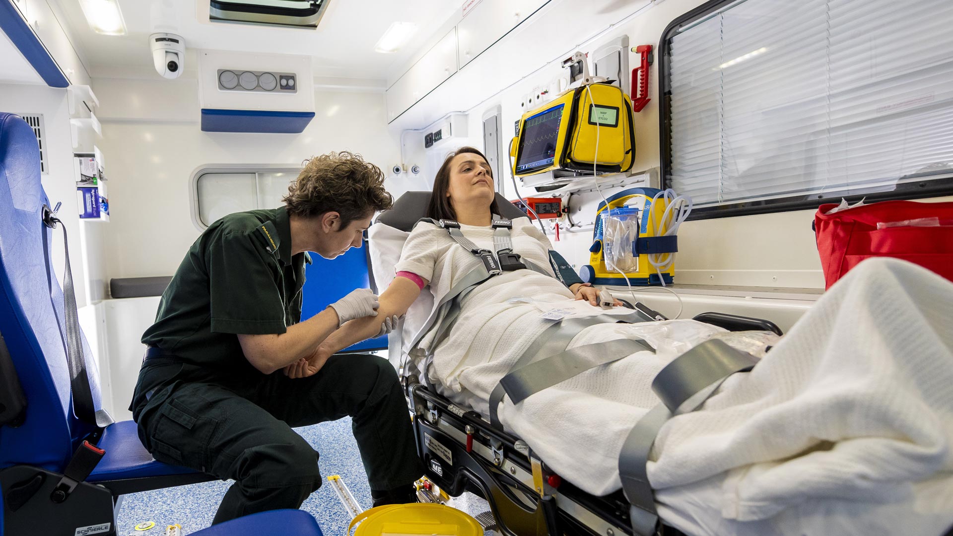 Student working on a patient in the mock ambulance