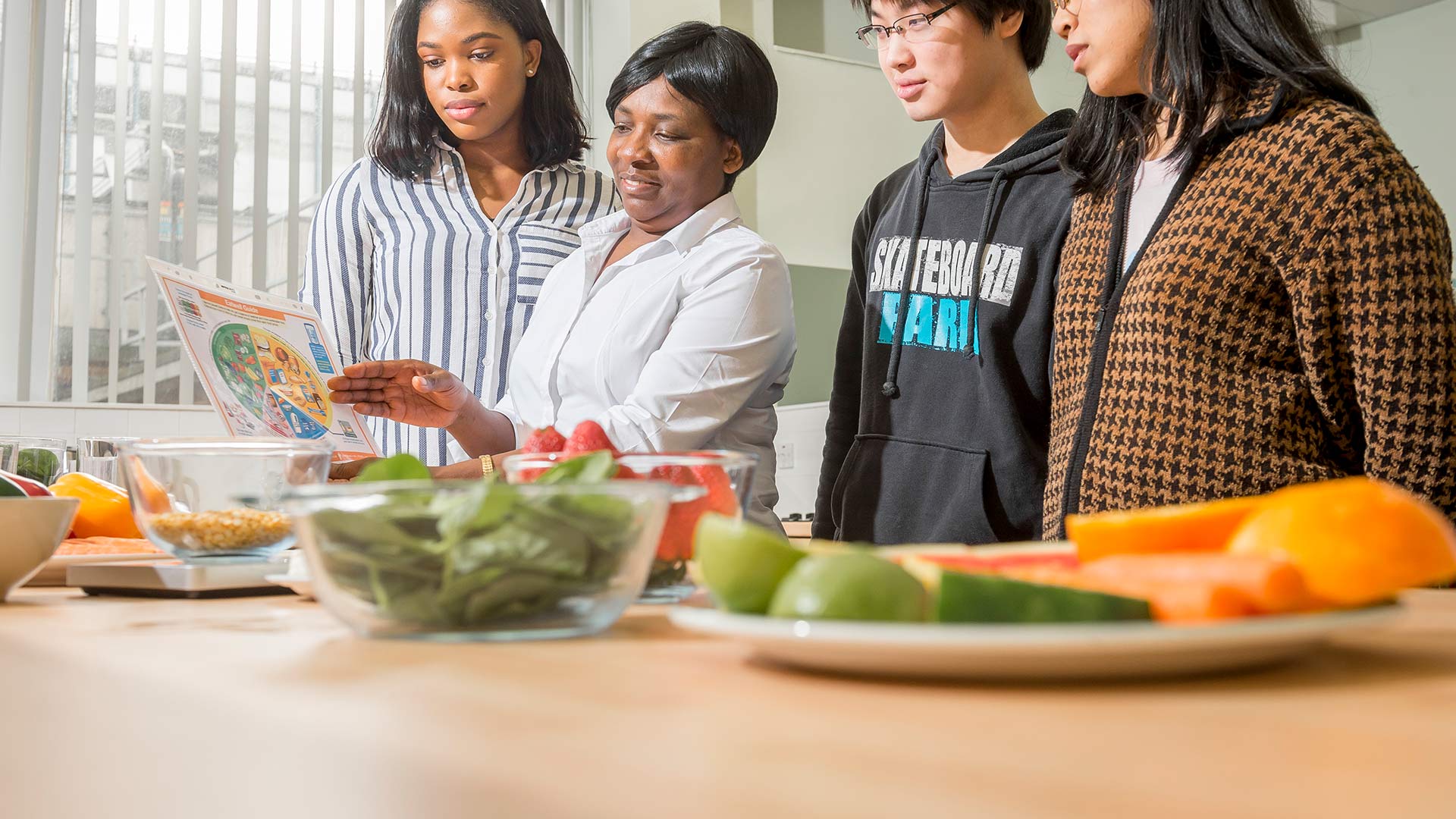 lecturer showing students a food chart