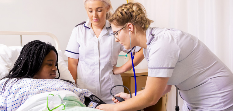 Nursing studenttaking an actor's blood pressure