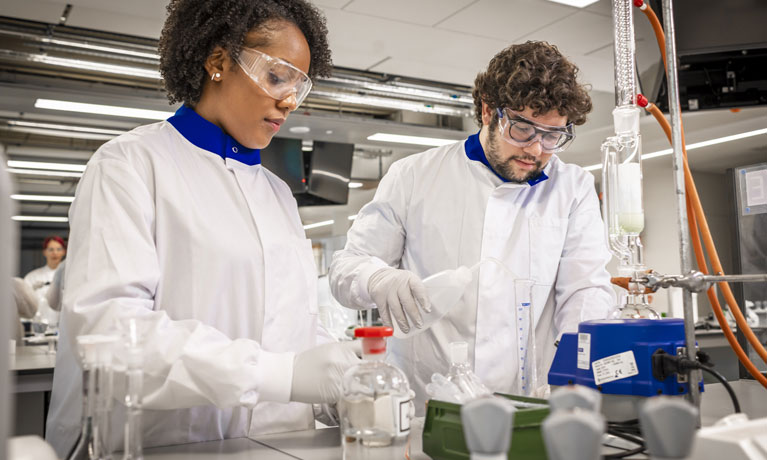 Two forensic science students using the biological lab