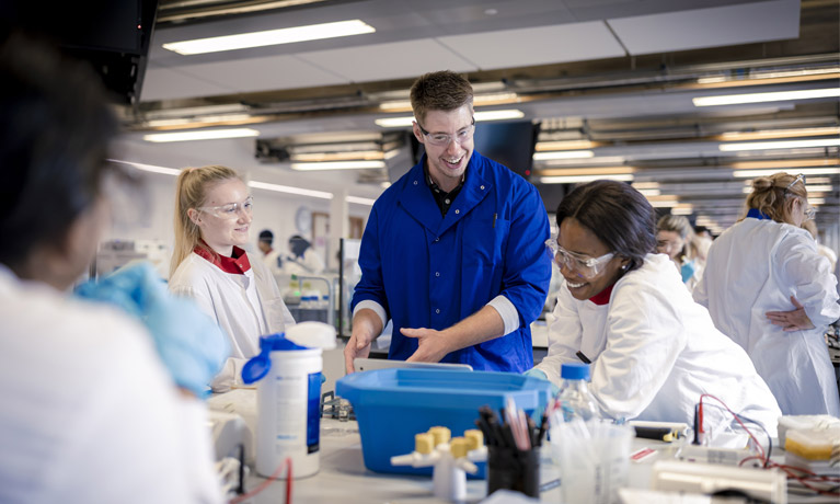 A lecturer with students in the SuperLab