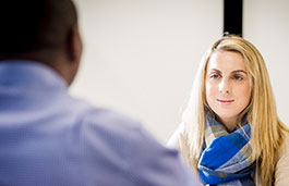 Closeup of a blonde young female wearing a blue scarf