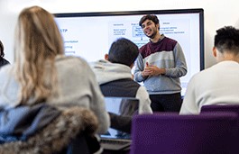 Lecturer standing in front of rows of students