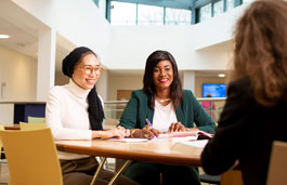 A group of students chatting around a table