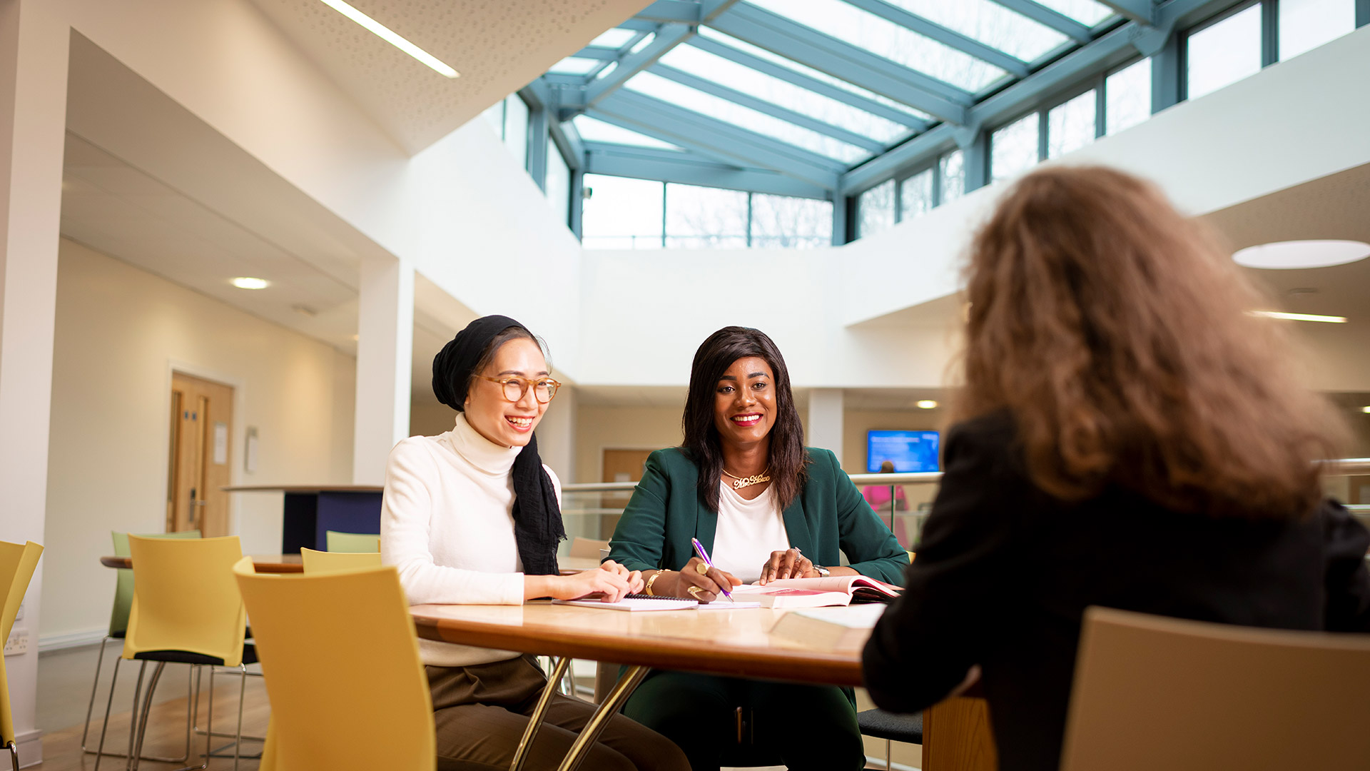 A group of students chatting around a table