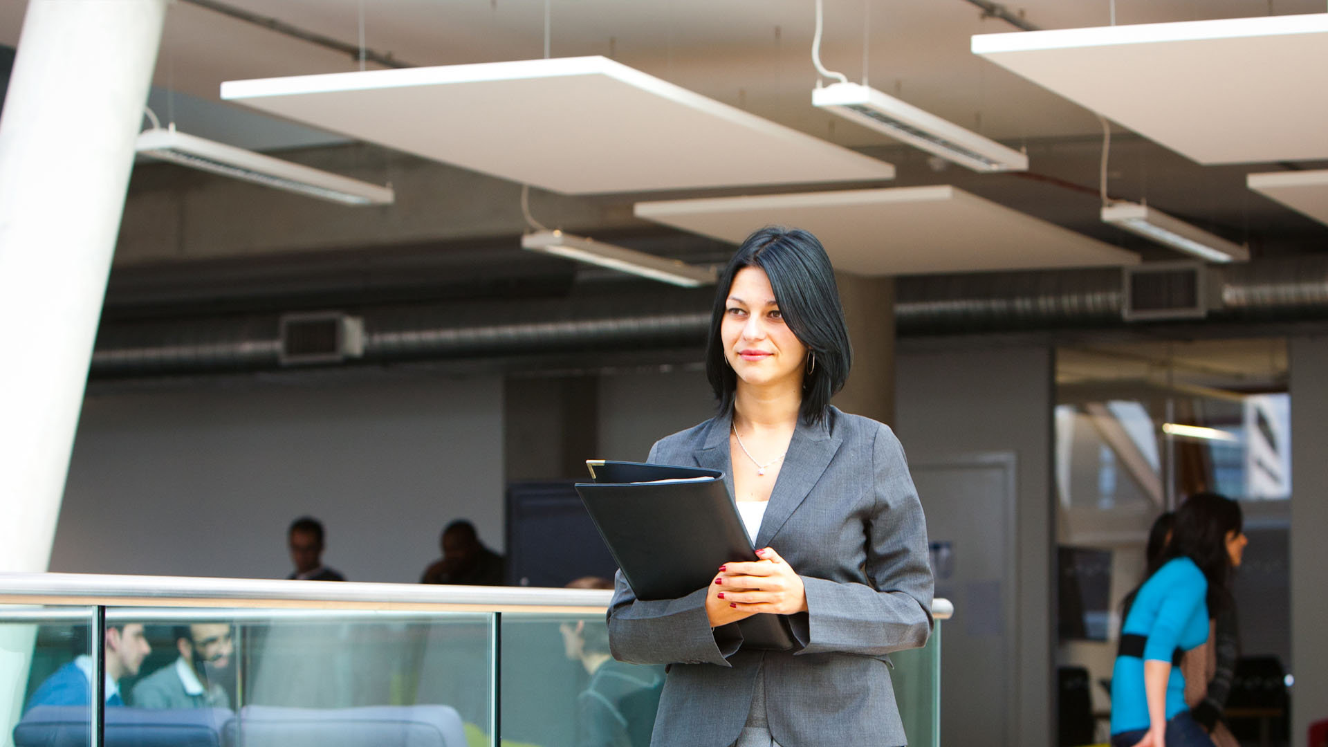 woman in business suit holding a folder