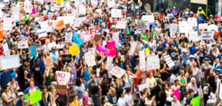 Large crowd holding up signs