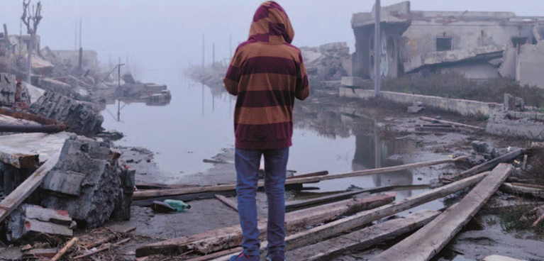 Person stood looking at destruction