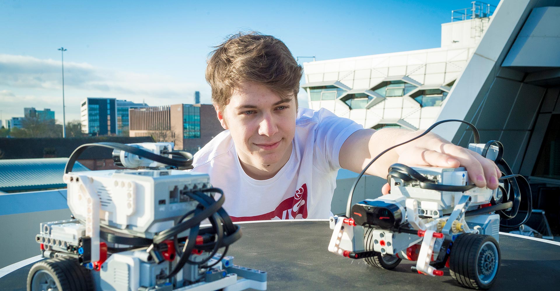 Young student working on a small remote controlled car.