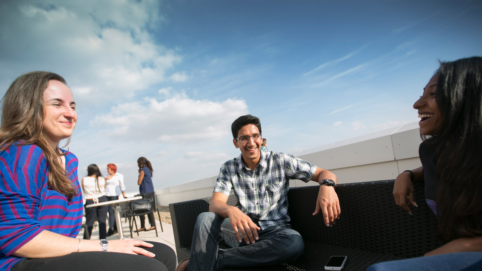 Group of students chatting in the Hub's rooftop garden.