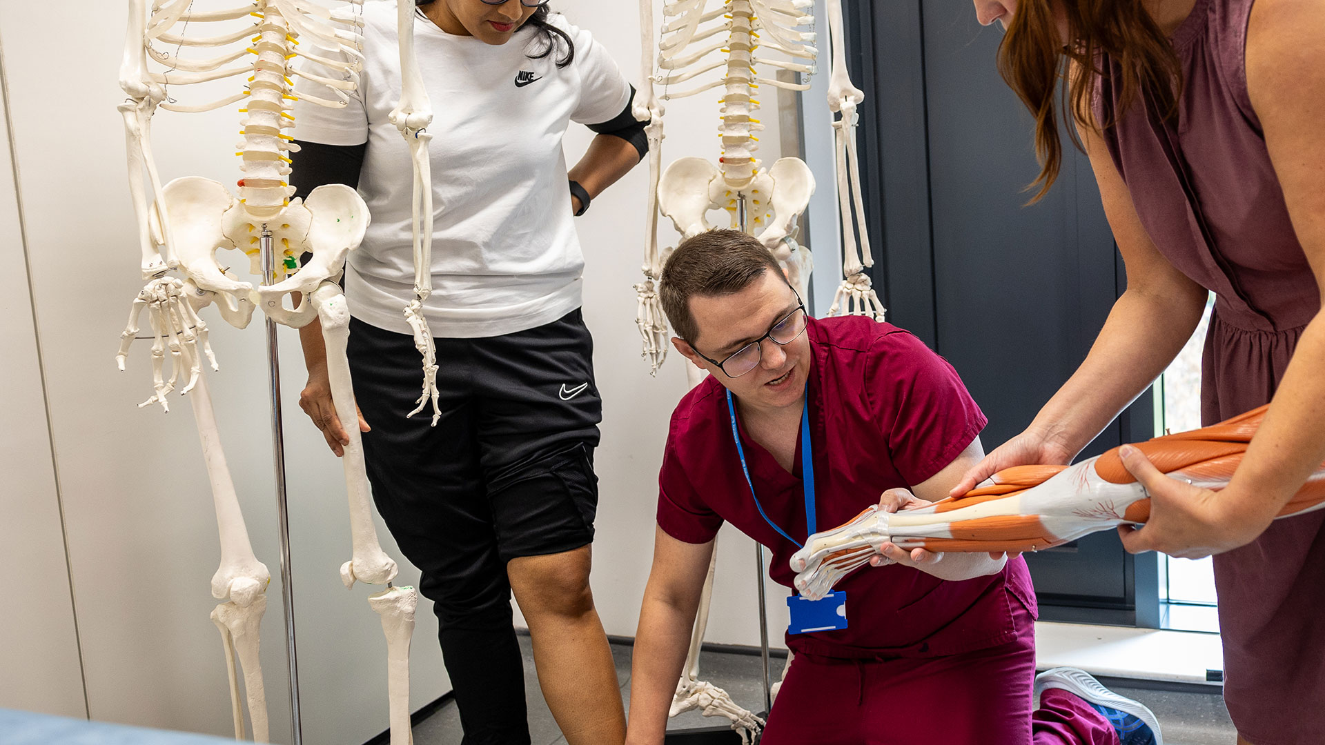 A podiatrist fitting an insole holding the patients foot 