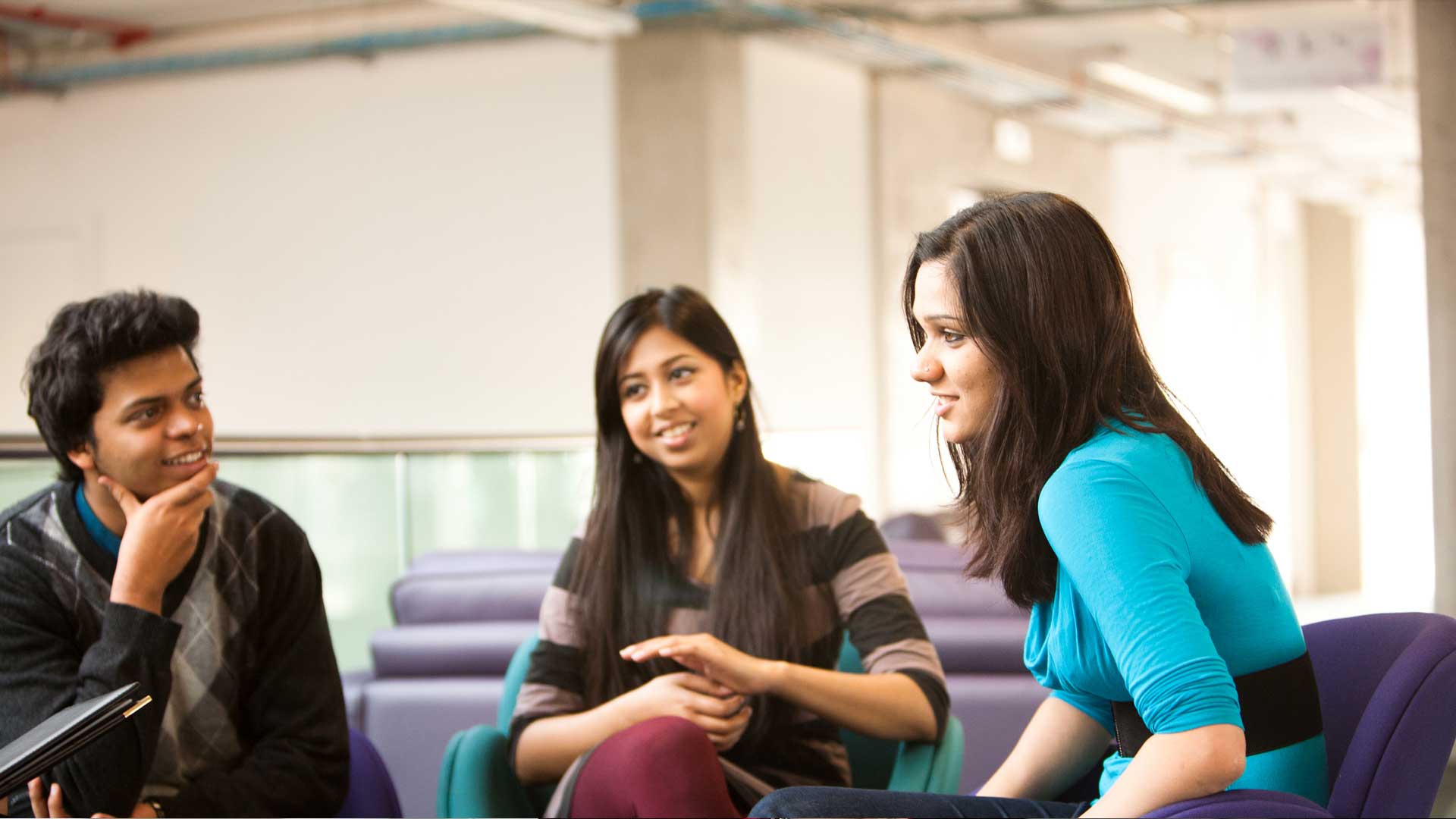 Group of students in a recreation area talking to eachother