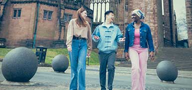 students walking in grounds outside Coventry Cathedral