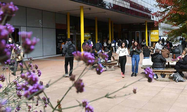 Students walking outside The Hub.