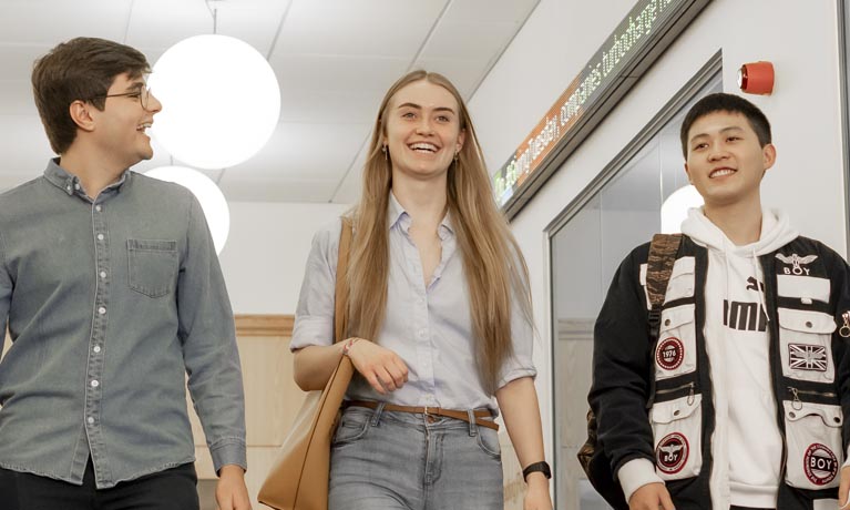 3 students walking along chatting