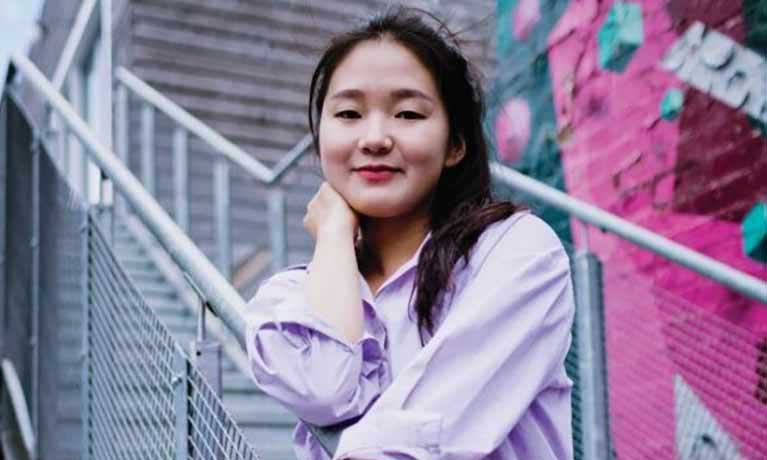 Student sitting on external stairs