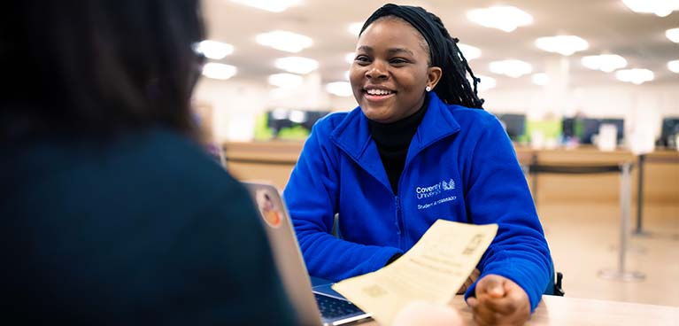 young female talking to another student