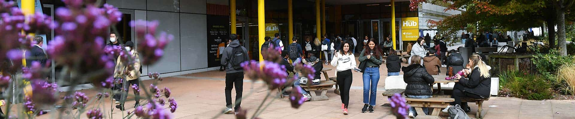 students walking in the distance outside the Hub