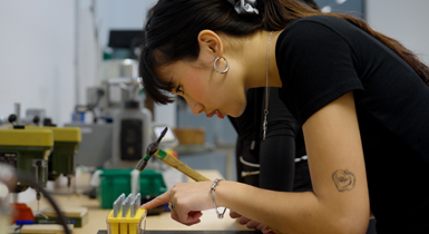 A student using the metal work lab in the Delia Derbyshire building